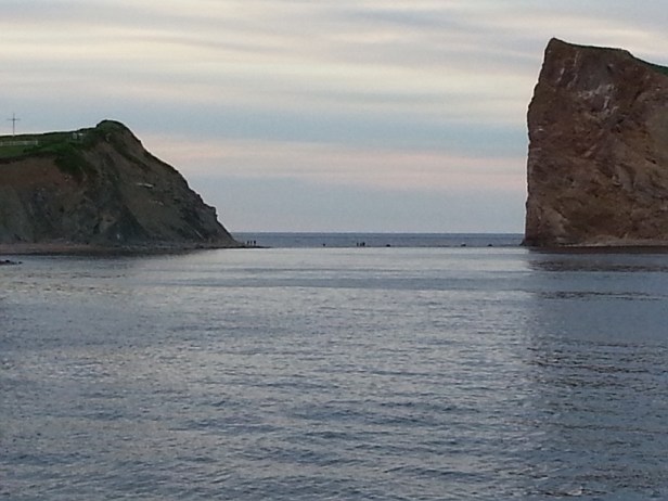 people walking across the sandbar